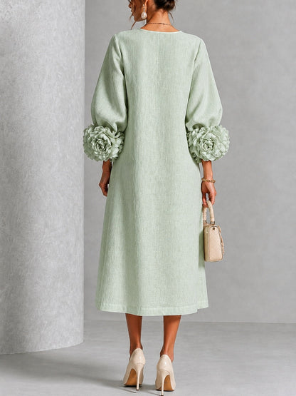 Vestido midi verde salvia con botones y puños de flores